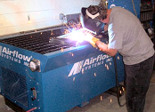 Downdraft table collects welding smoke.