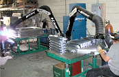 Dual arm portable air cleaner collects welding smoke.