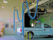 Vehicle exhaust hose drops for a motor pool repair facility.