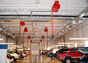 Vehicle exhaust hose reels for a car dealership.