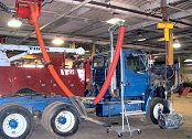 Hose reel for removal of diesel exhaust in truck repair shop.